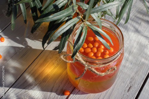 Seabuckthorn oil bottle with berries branches