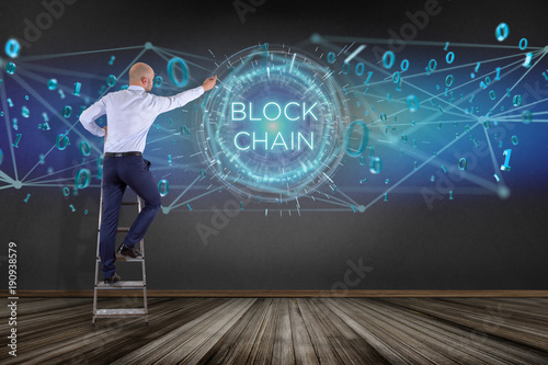 Businessman in front of a wall with blockchain title with 0 and 1 data flying over