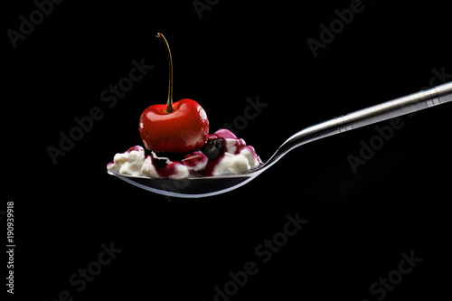 Dessert with cherry, cottage cheese and jam on spoon isolated. healthy food. Breakfast concept.