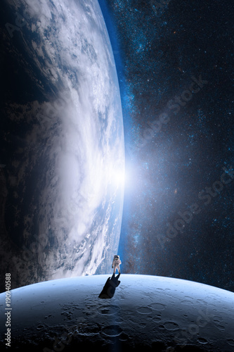 Fototapeta Naklejka Na Ścianę i Meble -  Astronaut is walking on the moon. Elements of this image furnished by NASA.