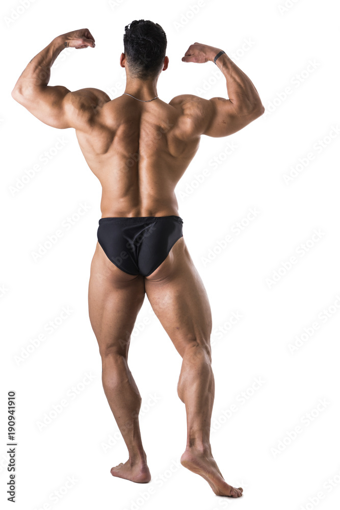 Handsome shirtless bodybuilder man, standing, in studio shot, isolated on white