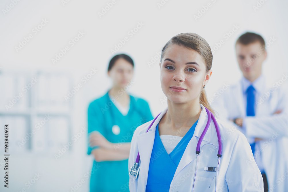 Attractive female doctor in front of medical group. Attractive female doctor in front of medical group.