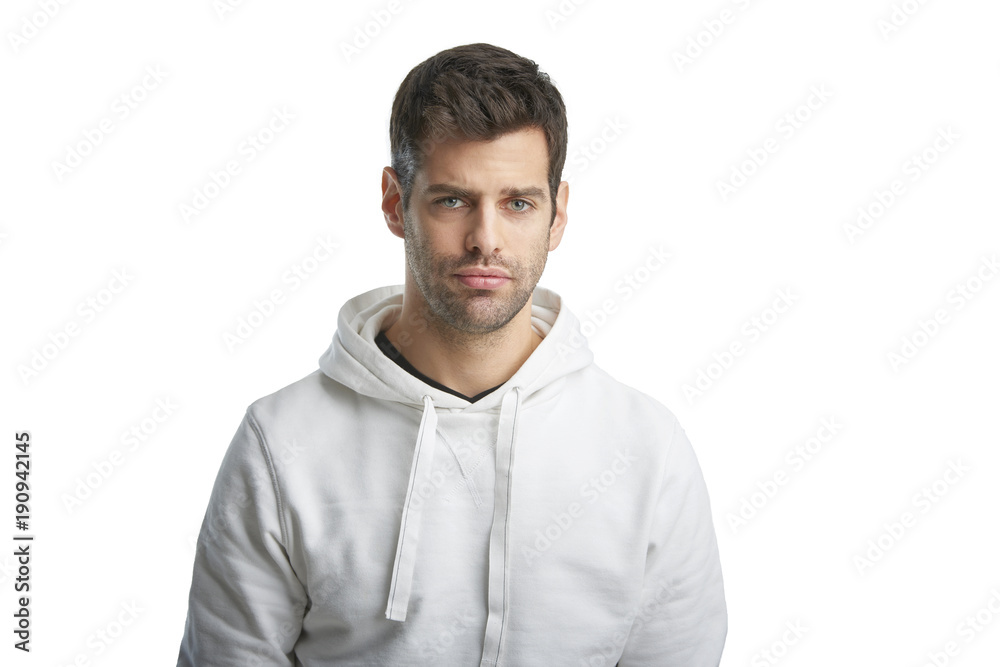 Obraz premium Casual young man portrait. Portrait of young man wearing hoodie while standing at isolated white background with copy space. 