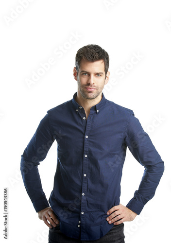 Confident young professional man portrait. Smiling young businessman standing at isolated white background and looking at camera. 
