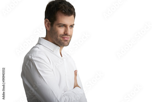 Confident young professional man portrait. Smiling young businessman standing at isolated white background. 