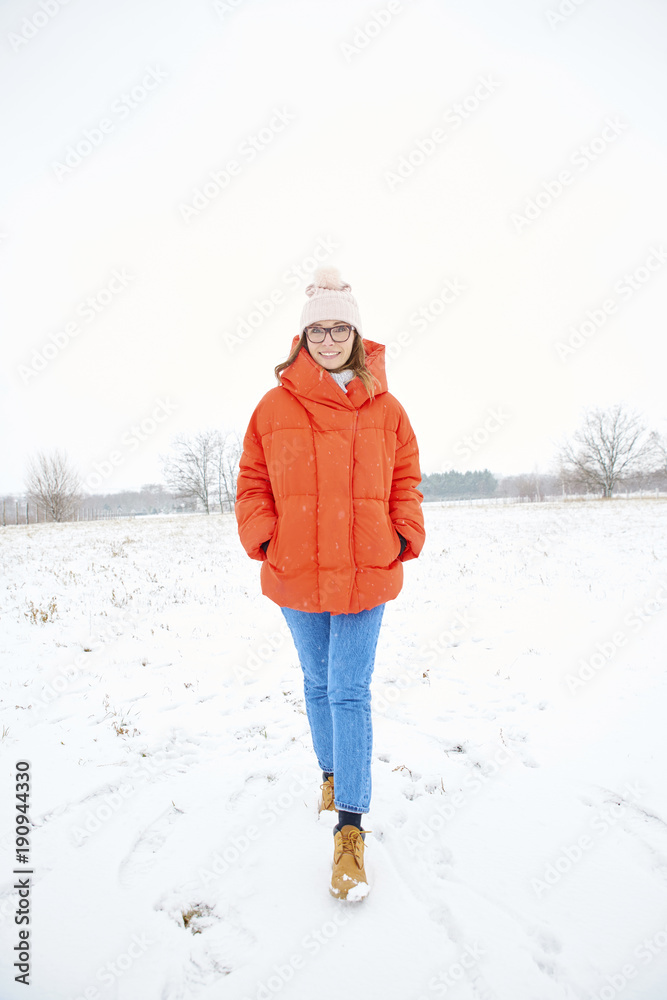 Full length shot of a happy woman enjoy winter weather outdoor and walking alone. Full length shot of a happy woman enjoy winter weather outdoor and walking alone.