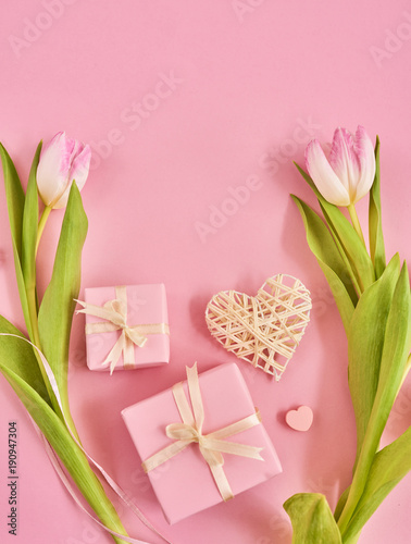 Valentines Day background with pink tulips, red ribbon and gift box over pink background. Space for text © Agave Studio