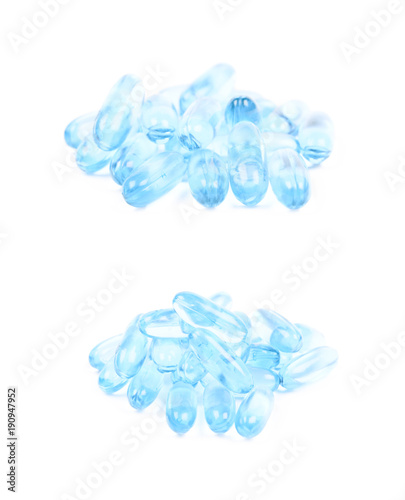 Pile of blue softgel pills isolated