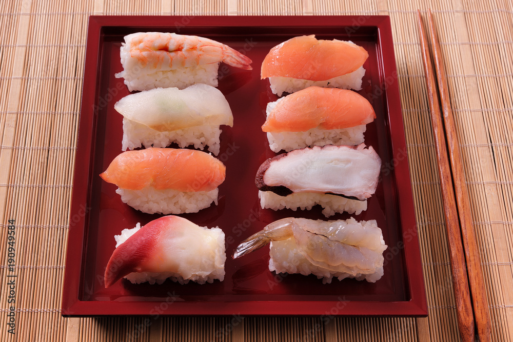 Sushi japanese japan food various selection raw fish salmon prawn shrimp in a row line on a bamboo lacquer tray photo Sushi japanese japan food various selection raw fish salmon prawn shrimp in a row line on a bamboo lacquer tray photo