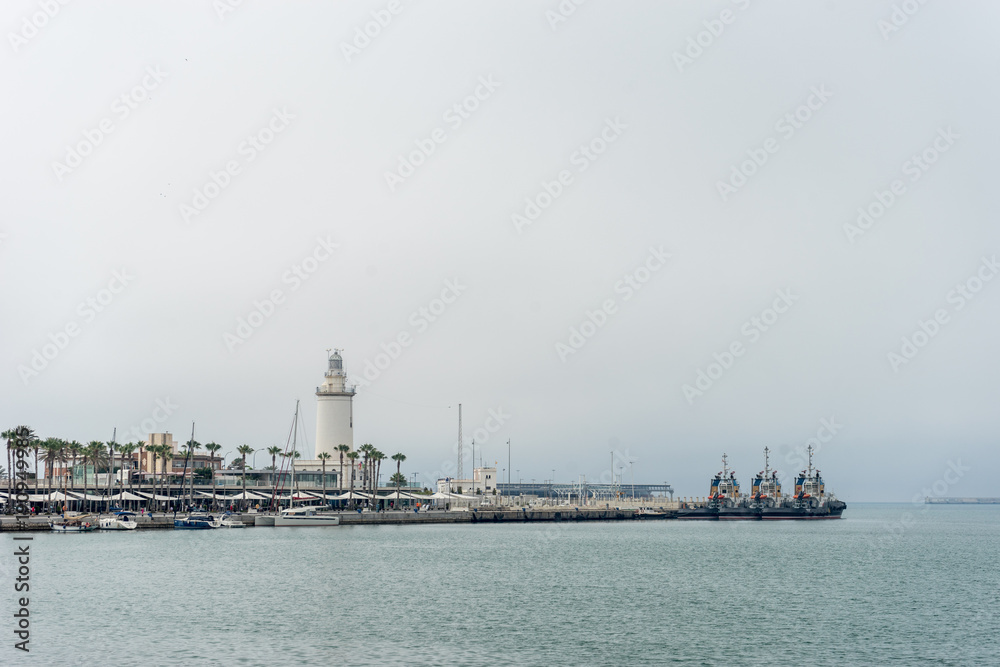 Lighthouse and ships along the coastline at Malaga, Spain, Europe