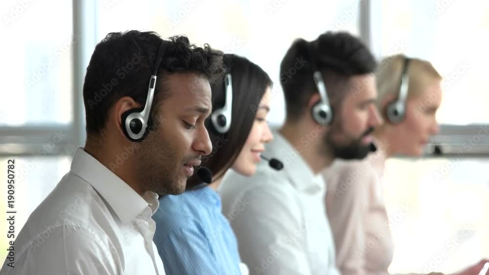 Vidéo Stock Black employee in call center and co-workers behind. Indian ...