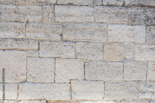 The wall is lined with stones. Building with cobblestones. Background of stones.