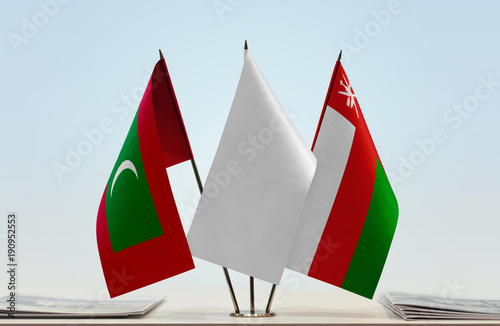 Flags of Maldives and Oman with a white flag in the middle