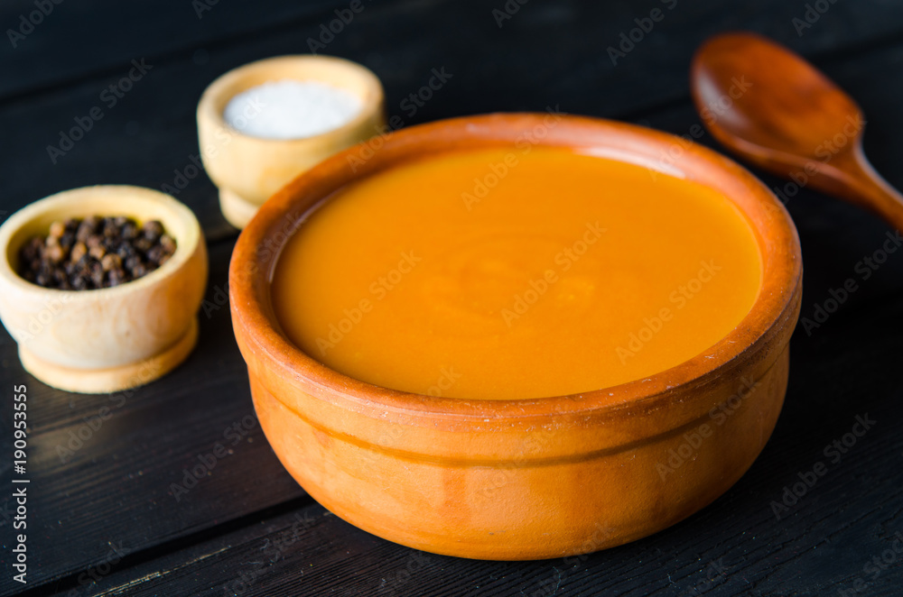 Pumpkin soup served on the table in bowl Pumpkin soup served on the table in bowl