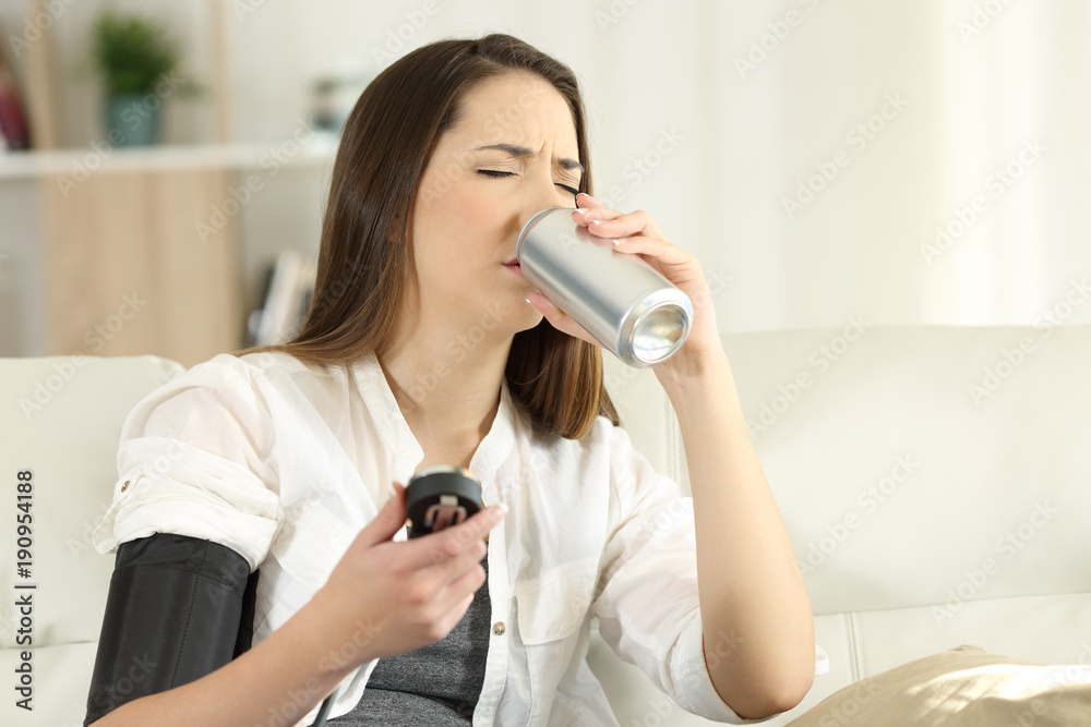 Woman with low blood pressure drinking sweet soda Woman with low blood pressure drinking sweet soda