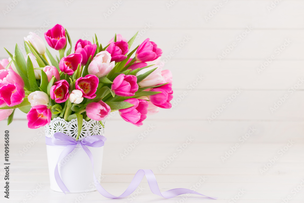Obraz premium Pink tulip on the white background. Easter background