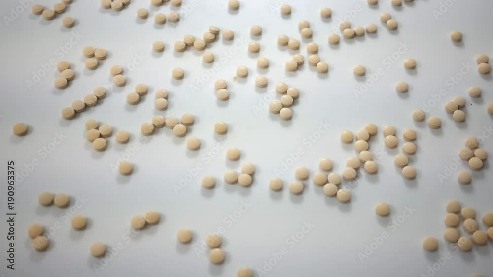 Spinning Vitamin C pills spinning over white cyc photography background - Overhead Angle Spinning Vitamin C pills spinning over white cyc photography background - Overhead Angle
