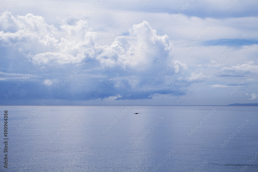 Obraz premium Sea and sky double landscape. Seashore view with fishing boat.