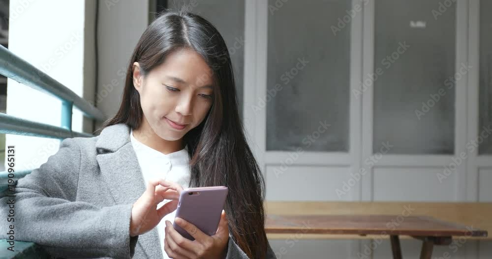Businesswoman using smart phone in coffee shop Businesswoman using smart phone in coffee shop