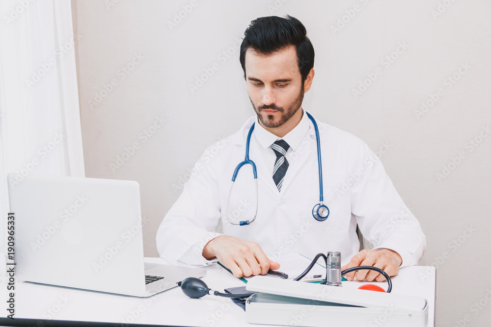 Doctor and stethoscope working with laptop computer in hospital.healthcare and medicine Doctor and stethoscope working with laptop computer in hospital.healthcare and medicine