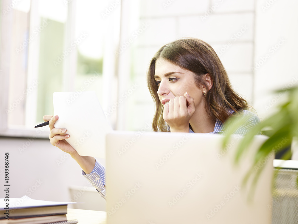 young caucasian businesswoman working in office young caucasian businesswoman working in office