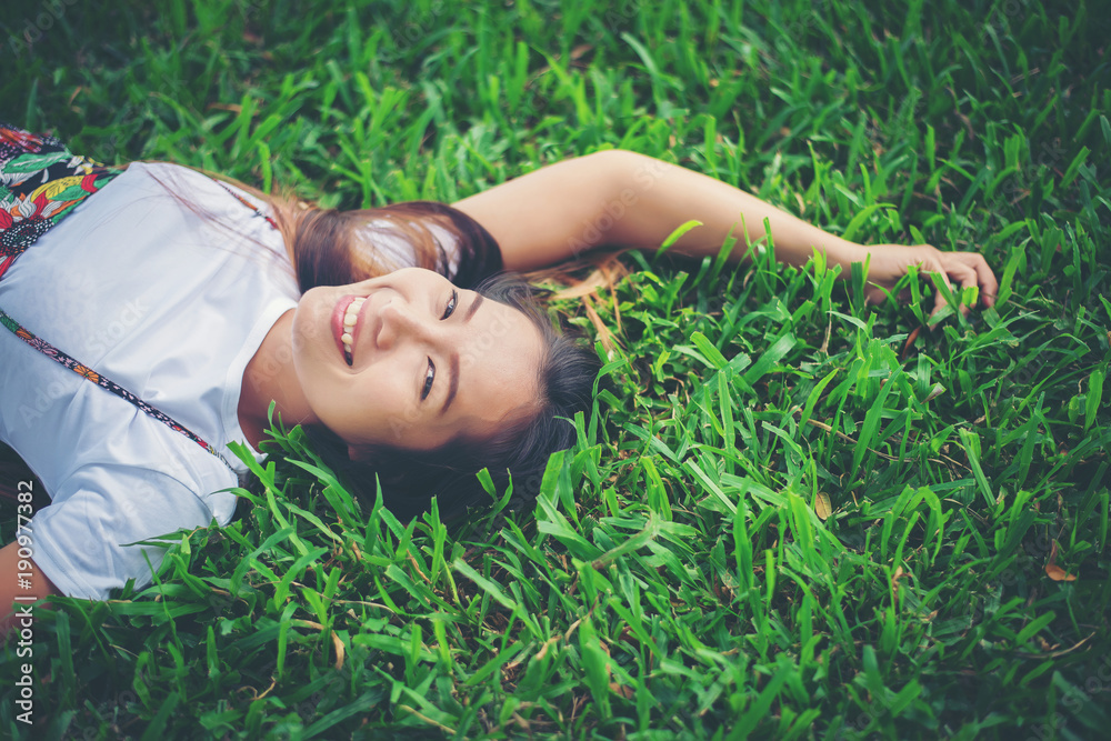Young woman lying down on grass. relax time. Young woman lying down on grass. relax time.