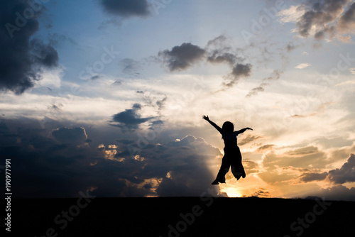 Wallpaper Mural Silhouette of Happy woman jumping and sunset Torontodigital.ca