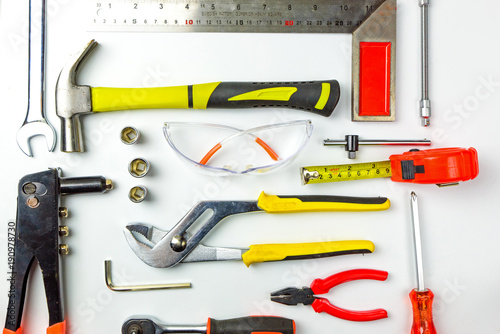 Set of construction tools on white background as wrench, hammer, pliers, socket wrench, spanner, tape measure, electric drill,safety glasses, screwdriver