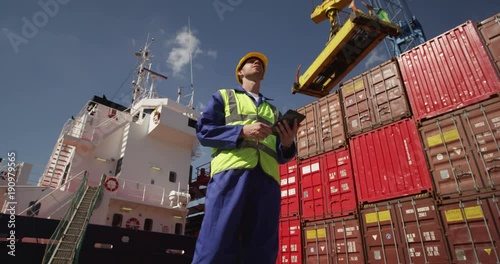 A young manager doing inspection rounds through an industrial harbor. Shot on RED Epic.