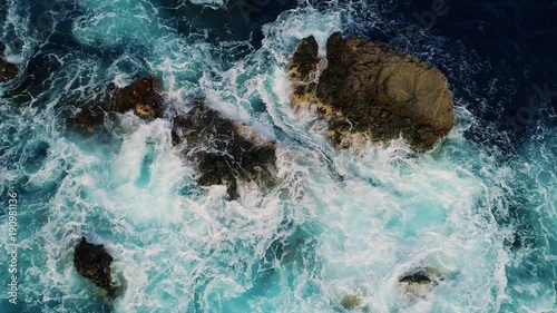 slow motion top down view of waves and clifs