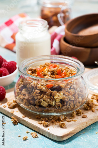 homemade granola with dried apricots and nuts for breakfast, vertical