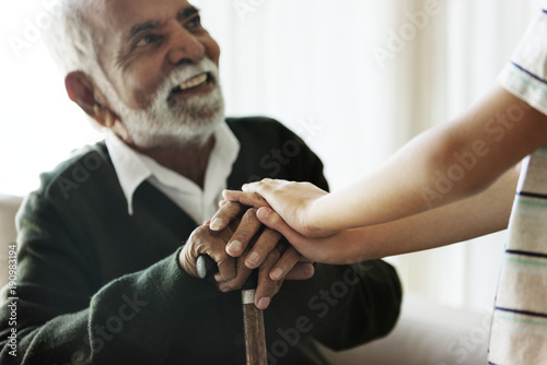 Senior man sitting talking with his relative photo