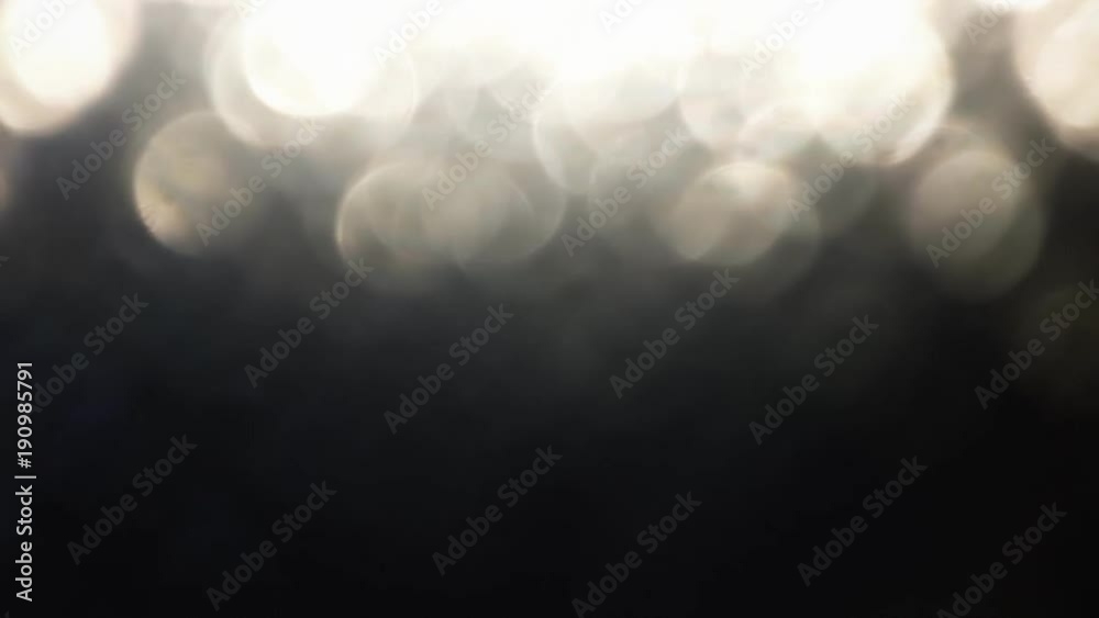 A white lens flare reflection, creating many beautiful round bouncing bokeh shapes in a corner of the frame.
A white lens flare reflection, creating many beautiful round bouncing bokeh shapes in a corner of the frame.