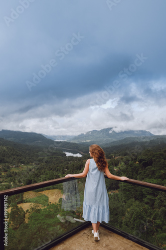 Young woman looking at mountains and lakes