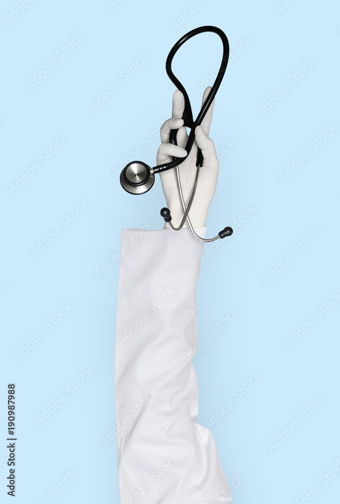 Hand with glove holding stethoscope Hand with glove holding stethoscope