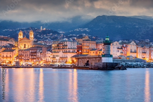 Bastia, a beautiful city landscape, a port with boats, a sunset and the lights of a night city. France, Corsica, a popular destination for travel in Europe photo