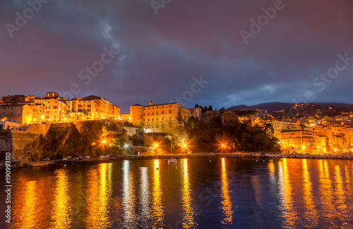 Bastia  a beautiful city landscape  a port with boats  a sunset and the lights of a night city. France  Corsica  a popular destination for travel in Europe
