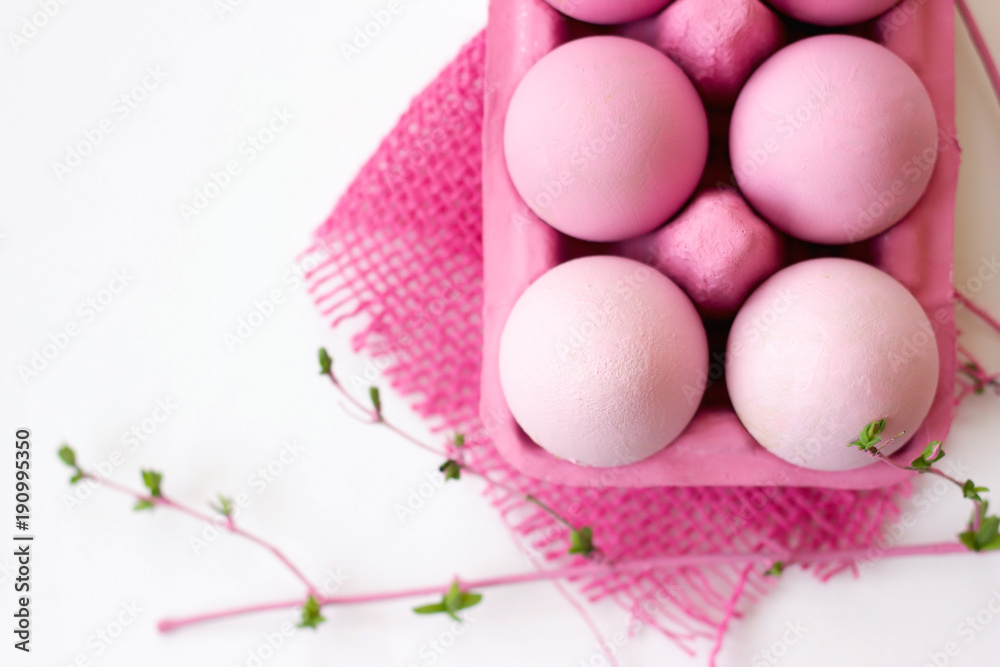 Pink easter eggs in pink box with decoration, on white background with copy space; easter wallpaper Pink easter eggs in pink box with decoration, on white background with copy space; easter wallpaper