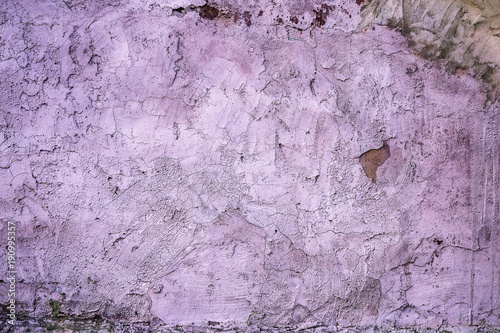 Grunge wall of the old house. Textured background. Plaster hue Ultra Violet
