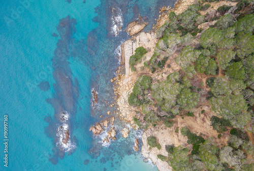 Aerial views of the rocks in the sea on a sunny day.