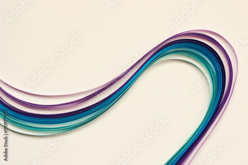 Decorative blue and violet paper stripes on white background with copy space; abstract lines background
