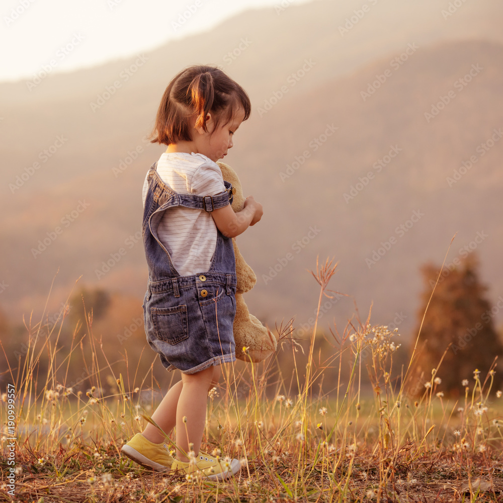 Sad little girl feeling alone in the park concept. Lonely ...