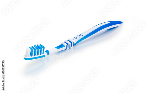 White and blue toothbrush on a white matte surface
