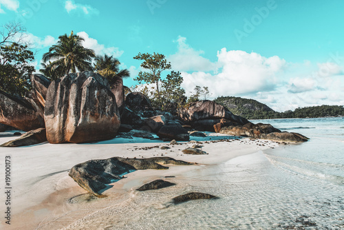 Idyllic tropical island beach with rock formation