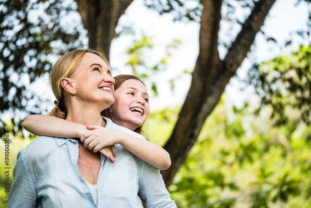 Mother and daughter having fun together in a park. Family and lifestyle concept Mother and daughter having fun together in a park. Family and lifestyle concept