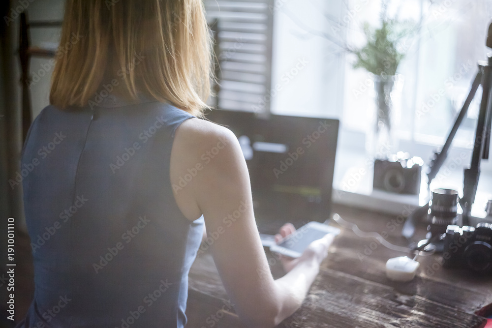 Workplace with open laptop with black screen on modern wooden desk, angled notebook on table in home interior, filtered image. Photographer, camera Workplace with open laptop with black screen on modern wooden desk, angled notebook on table in home interior, filtered image. Photographer, camera