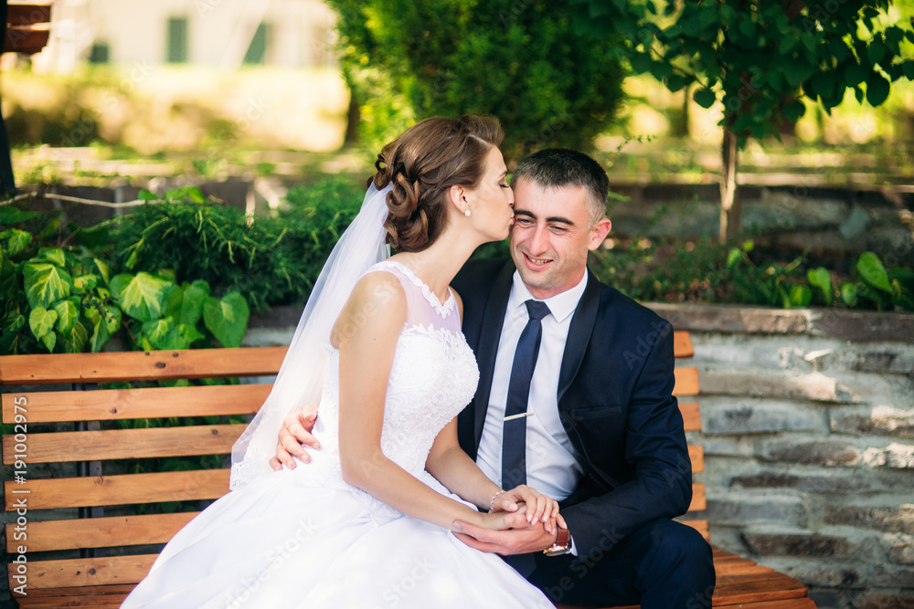 Bride and groom siting on the bench Bride and groom siting on the bench