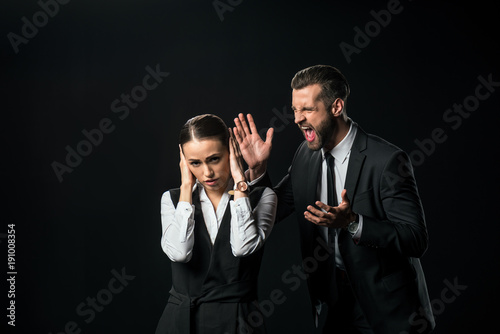 angry boss yelling at businesswoman, isolated on black