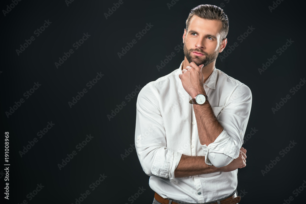 handsome thoughtful businessman in white shirt, isolated on black handsome thoughtful businessman in white shirt, isolated on black