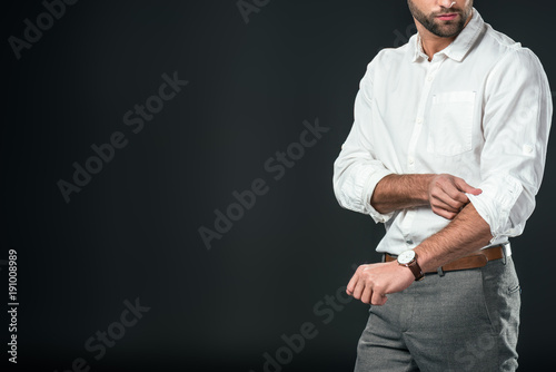 cropped view of handsome businessman in white shirt, isolated on black